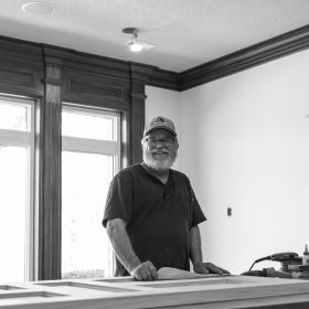 Ritch Miller sanding a door for a family room in Johnston, Iowa.