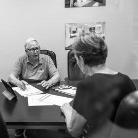 Rollie Clarkson meeting with a client about a kitchen remodel; Urbandale, Iowa.