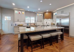 Kitchen remodel with black cabinets, grey walls and beautiful countertops.