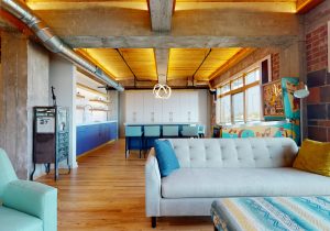 A home graced with natural wood flooring and tray lighting that casts a soft glow across the ceiling.