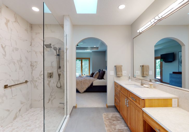Transitional Bathroom: Features a marble shower, and bronze accents in the space.