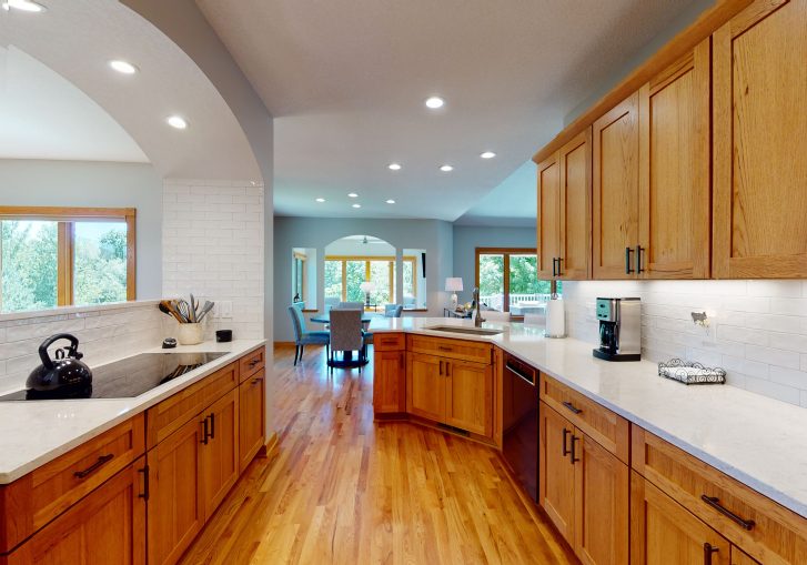 Transitional Kitchen: Wood cabinets, with white backsplash, and matching solid surface countertops.