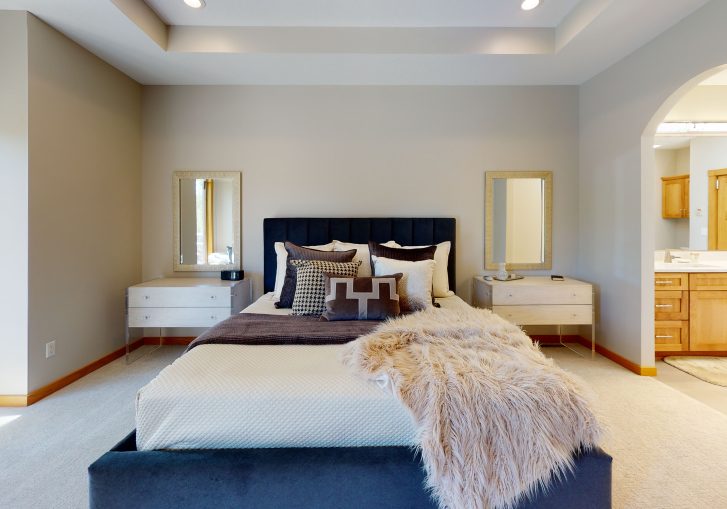 This transitional style bedroom is accented with beautifully made furnishings.