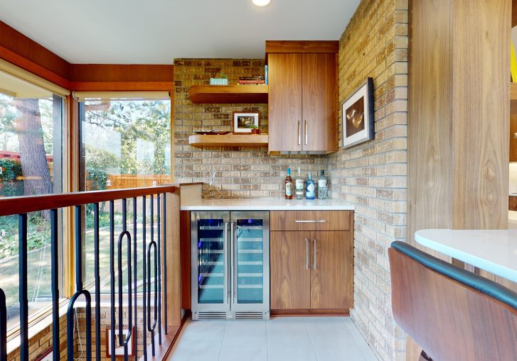 This mid-century modern kitchen remodel embraces clean lines, natural materials, and functional elegance. At its heart are our Signature Cornerstone custom grain-matched walnut cabinets in a rich natural finish, offering a seamless, sophisticated look.