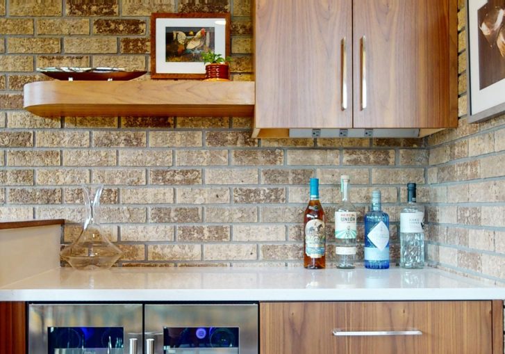 This mid-century modern kitchen remodel embraces clean lines, natural materials, and functional elegance. At its heart are our Signature Cornerstone custom grain-matched walnut cabinets in a rich natural finish, offering a seamless, sophisticated look.