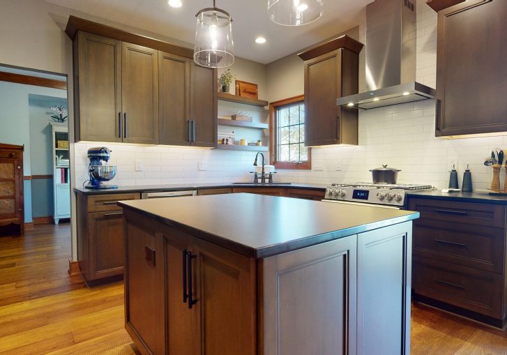 This traditional kitchen remodel in Ankeny, Iowa, showcases the timeless beauty and functionality of suede leather quartz countertops. The countertops not only provide a smooth, durable surface for cooking and meal prep but also add a luxurious touch to the overall kitchen design. Their sleek, matte finish complements the warm tones of the surrounding cabinetry and fixtures, creating a cohesive look.