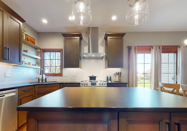 This traditional kitchen remodel in Ankeny, Iowa, showcases the timeless beauty and functionality of suede leather quartz countertops. The countertops not only provide a smooth, durable surface for cooking and meal prep but also add a luxurious touch to the overall kitchen design. Their sleek, matte finish complements the warm tones of the surrounding cabinetry and fixtures, creating a cohesive look.