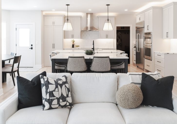 A standout feature of this kitchen is the hidden walk-in pantry, seamlessly integrated into the cabinetry for a clutter-free aesthetic while offering ample storage space. This discreet yet functional design element keeps essentials organized while maintaining the sleek kitchen aesthetic.