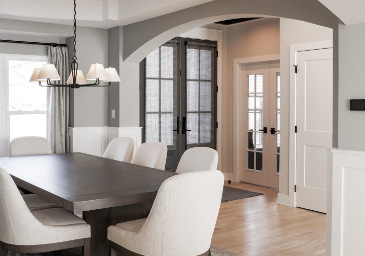 The modern dining room embraces transitional style, creating a versatile setting for both intimate dinners and larger gatherings. Its minimalist elegance, paired with thoughtful lighting and refined finishes, makes it the perfect space for entertaining.