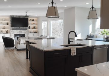 The kitchen remodel is a perfect blend of warm, moody tones and custom craftsmanship, featuring Cornerstone Cabinetry’s Signature line for a polished and timeless look. The cabinetry’s sleek, minimalist hardware enhances the clean lines, while high-end finishes add sophistication.