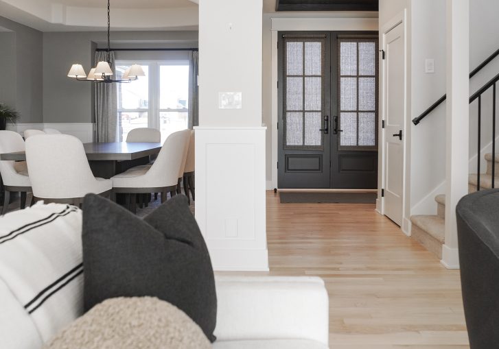 The open-concept layout connects the kitchen, mudroom, dining room, living room, and family room, ensuring both aesthetic cohesion and everyday convenience.