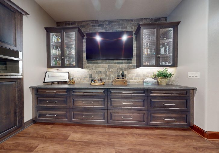 A standout feature of this remodel, the metal mesh whiskey cabinets offer both form and function. These secure yet stylish cabinets put your best bottles on display while subtly nodding to prohibition-era concealment. They’re a conversation piece that perfectly fits the theme.