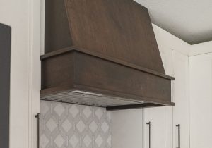 A custom wood hood adorns this kitchen remodel.
